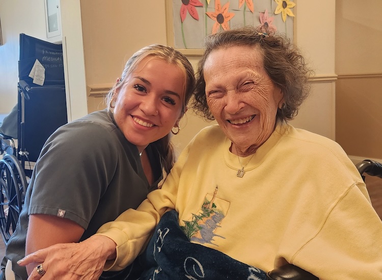 care staff smiling with sandyside senior living resident